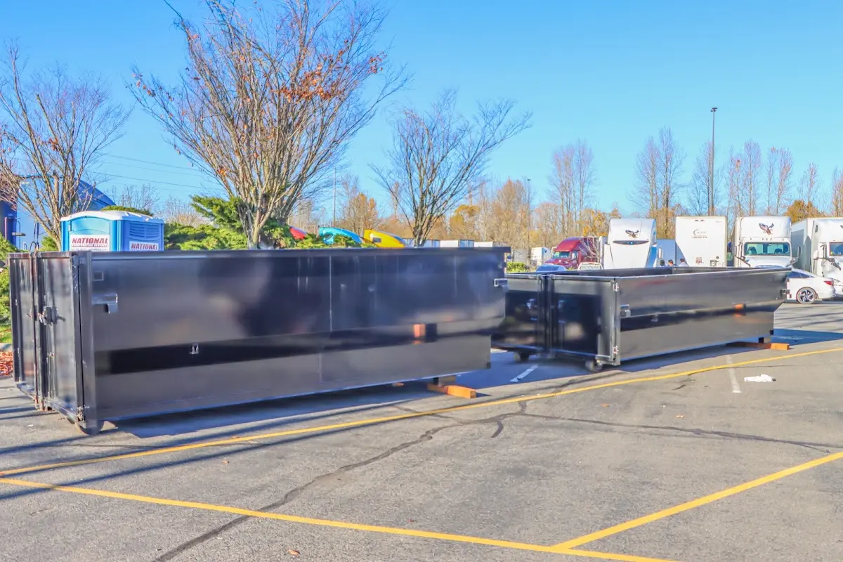 Professional dumpster rental service with roll-off container on residential driveway in Norfolk